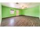 Spacious living room with new wood flooring and bright green walls at 5751 E Owens Ave, Las Vegas, NV 89110