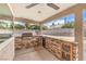 Outdoor kitchen area features stone accents, a built-in grill, and ample counter space at 5751 E Owens Ave, Las Vegas, NV 89110