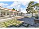 Charming backyard with brick patio, modern grass accents, and fire pit perfect for entertaining at 60 E Levi Ave, Las Vegas, NV 89183