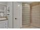 Bathroom featuring glass block shower, single sink vanity, and unique mirrored medicine cabinet at 60 E Levi Ave, Las Vegas, NV 89183