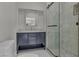Modern bathroom featuring a walk-in shower, updated vanity, and decorative mirror at 60 E Levi Ave, Las Vegas, NV 89183
