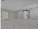 Spacious bonus room featuring a sliding barn door, neutral color scheme, and plenty of natural light at 60 E Levi Ave, Las Vegas, NV 89183