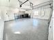 Spacious garage with epoxy floors, built-in cabinets, and modern laundry appliances at 60 E Levi Ave, Las Vegas, NV 89183