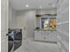 Well-lit laundry room with modern washer and dryer, white cabinets, and tiled floors at 60 E Levi Ave, Las Vegas, NV 89183