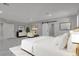 Stylishly furnished main bedroom with tile floors, neutral paint, recessed lights, and view to adjacent room via sliding barn door at 60 E Levi Ave, Las Vegas, NV 89183
