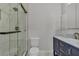 Modern shower with glass door, sleek fixtures, and white tile walls, offering a clean and stylish design at 60 E Levi Ave, Las Vegas, NV 89183