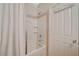 Bright bathroom with a white shower-tub combo featuring tile surround and built-in shelves at 6255 W Arby Ave # 193, Las Vegas, NV 89118
