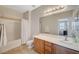 Bright bathroom with a large mirror, wood cabinets, shower-tub combo and neutral color palette at 6255 W Arby Ave # 193, Las Vegas, NV 89118
