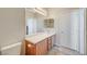 Bathroom featuring a wood vanity, white countertop, a large mirror, and a tiled floor at 6255 W Arby Ave # 193, Las Vegas, NV 89118