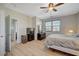 Comfortable bedroom featuring hardwood floors, ceiling fan, and ensuite bathroom at 6255 W Arby Ave # 193, Las Vegas, NV 89118