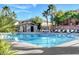 Inviting community pool area with lounge chairs, clubhouse, and mature palm tree landscaping at 6255 W Arby Ave # 193, Las Vegas, NV 89118