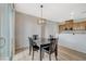 Bright dining area with wood floors and modern lighting near the kitchen and sliding doors at 6255 W Arby Ave # 193, Las Vegas, NV 89118