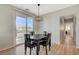 Bright dining area features wood floors, modern lighting, and sliding glass doors to a balcony at 6255 W Arby Ave # 193, Las Vegas, NV 89118