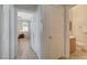 Hallway leading to a bathroom and bedroom, featuring a closet with folding doors at 6255 W Arby Ave # 193, Las Vegas, NV 89118