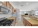 Well-lit kitchen featuring granite countertops and stainless steel gas range at 6255 W Arby Ave # 193, Las Vegas, NV 89118