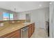 Bright kitchen featuring granite countertops, stainless steel appliances, and tile flooring at 6255 W Arby Ave # 193, Las Vegas, NV 89118