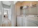 Well-equipped laundry room with washer, dryer, and storage shelves at 6255 W Arby Ave # 193, Las Vegas, NV 89118