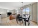 Open-concept living room boasts wood floors, modern lighting, and sliding glass doors to the balcony at 6255 W Arby Ave # 193, Las Vegas, NV 89118