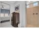 Bathroom showcasing a large tiled shower and adjacent dresser, filled with towels at 8286 Skye Gorge St, Las Vegas, NV 89166