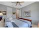 Neutral bedroom showcasing a bed, ceiling fan, and wall decorations in a cozy setting at 8286 Skye Gorge St, Las Vegas, NV 89166
