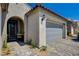 This home offers an arched entry, desert landscaping, and an attached two car garage at 8286 Skye Gorge St, Las Vegas, NV 89166