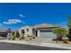 This house features desert landscaping, a grey garage door, and a paved driveway at 8286 Skye Gorge St, Las Vegas, NV 89166