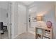 Hallway with neutral walls, multiple doorways, and a decorative side table with a lamp at 8286 Skye Gorge St, Las Vegas, NV 89166