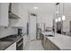 Stylish kitchen with white cabinets, stainless steel appliances, and a modern island with pendant lighting at 8286 Skye Gorge St, Las Vegas, NV 89166