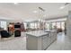 Open-concept kitchen with stainless steel appliances, modern countertops, and a spacious island with seating at 8286 Skye Gorge St, Las Vegas, NV 89166