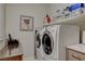 Laundry room featuring a modern washer and dryer, stainless steel sink, and overhead storage at 8286 Skye Gorge St, Las Vegas, NV 89166
