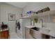 Bright laundry room with modern washer/dryer, stainless steel sink, and ample shelving at 8286 Skye Gorge St, Las Vegas, NV 89166