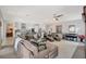 Bright and airy living room boasts a large sectional, piano, and seamless flow to the modern kitchen at 8286 Skye Gorge St, Las Vegas, NV 89166