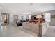 Spacious living room featuring neutral color palette, plush sofa, tile flooring, and lots of natural light at 8286 Skye Gorge St, Las Vegas, NV 89166