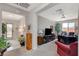 Inviting living area featuring neutral tones, a ceiling fan, and natural light from a large window at 8286 Skye Gorge St, Las Vegas, NV 89166