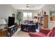 Comfortable office space with a large window, ceiling fan, and built-in bookshelves at 8286 Skye Gorge St, Las Vegas, NV 89166