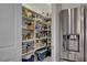 Walk-in pantry with ample shelving space and easy access to refrigerator, perfect for organizing groceries at 8286 Skye Gorge St, Las Vegas, NV 89166