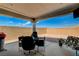 This covered patio has a BBQ, dining table, and desert landscaping at 8286 Skye Gorge St, Las Vegas, NV 89166