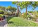 Well-maintained backyard features green lawn, mature trees, and privacy landscaping at 8620 Cremona Dr, Las Vegas, NV 89117