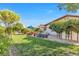 Lush backyard featuring a well-manicured lawn, mature trees, privacy fence and shaded seating area, perfect for outdoor relaxation at 8620 Cremona Dr, Las Vegas, NV 89117