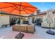 Covered patio area with comfortable outdoor seating, grill, and access to the house through sliding doors at 8620 Cremona Dr, Las Vegas, NV 89117