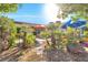 Picturesque backyard with stone landscaping, lush plants, and a view of the patio area at 8620 Cremona Dr, Las Vegas, NV 89117