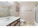 Bathroom featuring tile surround, shower, vanity with sink, and updated fixtures at 8620 Cremona Dr, Las Vegas, NV 89117