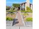 Inviting home with a brick walkway and beautifully maintained garden beds at 8620 Cremona Dr, Las Vegas, NV 89117