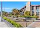 Beautifully landscaped front yard featuring a walkway and garden beds under a blue sky at 8620 Cremona Dr, Las Vegas, NV 89117