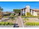 Charming home featuring a stone walkway and landscaped front yard with lush greenery at 8620 Cremona Dr, Las Vegas, NV 89117