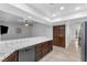 Open kitchen with dark wood cabinets, tile counters, and stainless-steel dishwasher at 8620 Cremona Dr, Las Vegas, NV 89117