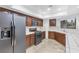 Kitchen featuring stainless steel refrigerator and dark wood cabinets at 8620 Cremona Dr, Las Vegas, NV 89117