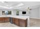 Bright kitchen features dark wood cabinets, tile countertops, and an adjacent living area at 8620 Cremona Dr, Las Vegas, NV 89117