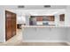 Open kitchen with dark wood cabinets, stainless steel appliances, and bar seating at 8620 Cremona Dr, Las Vegas, NV 89117
