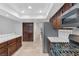 Well-lit kitchen showcases stainless steel appliances, tiled countertops, and dark wood cabinetry at 8620 Cremona Dr, Las Vegas, NV 89117